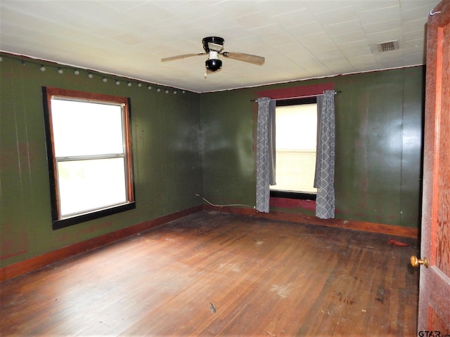 unfurnished room with ceiling fan and wood-type flooring