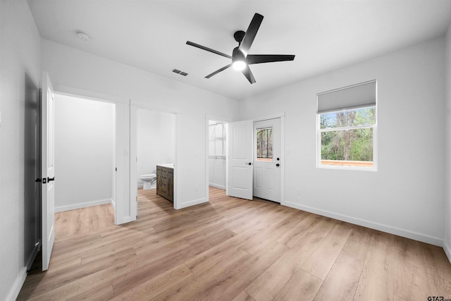 unfurnished bedroom featuring baseboards, a ceiling fan, visible vents, and light wood-type flooring