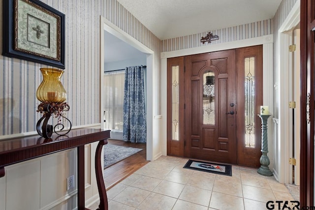 tiled foyer entrance with a textured ceiling