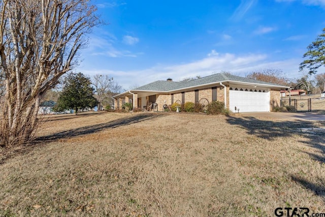 ranch-style house with a garage and a front yard