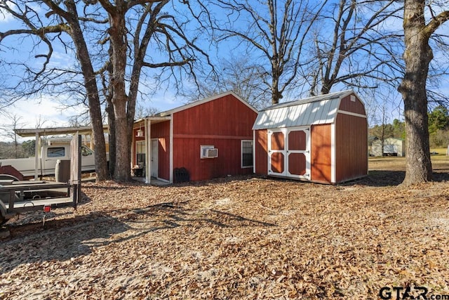 view of outbuilding featuring a wall mounted air conditioner