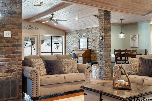 living room featuring ceiling fan, decorative columns, lofted ceiling with beams, wooden ceiling, and light wood-type flooring