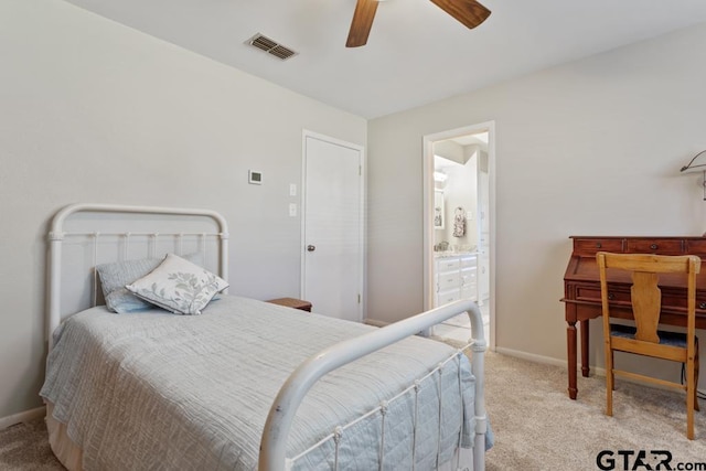 bedroom with ceiling fan, connected bathroom, and light colored carpet