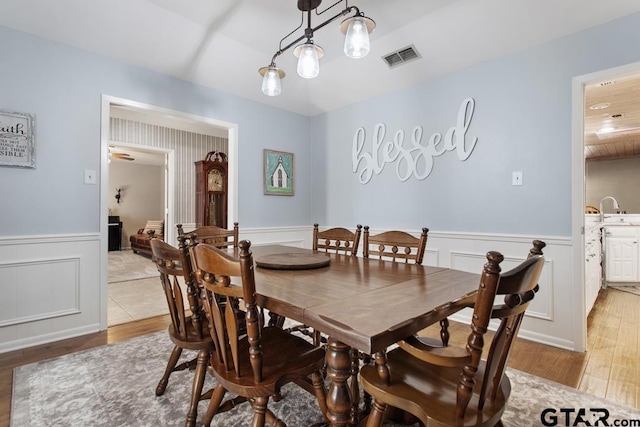 dining room with sink and light hardwood / wood-style floors