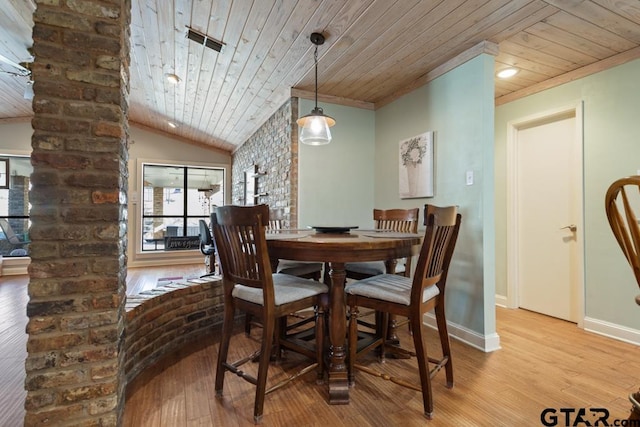 dining space featuring ornamental molding, wooden ceiling, and light hardwood / wood-style flooring