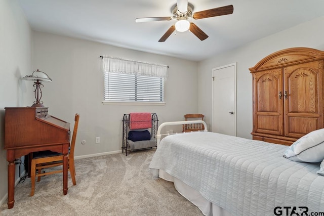 bedroom featuring ceiling fan and light carpet