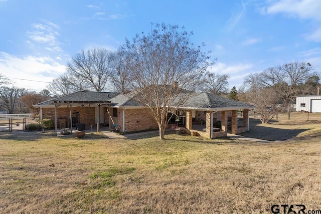 back of house with a patio and a yard