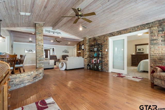 living room featuring wood ceiling, hardwood / wood-style flooring, lofted ceiling with beams, brick wall, and ornate columns