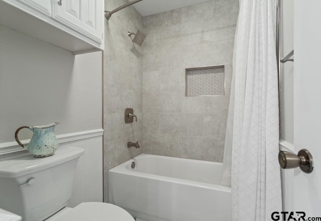 bathroom with shower / tub combo and toilet