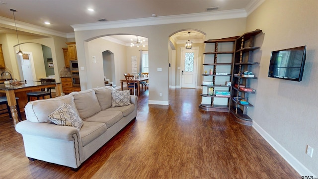 living room featuring arched walkways, visible vents, dark wood-type flooring, and ornamental molding