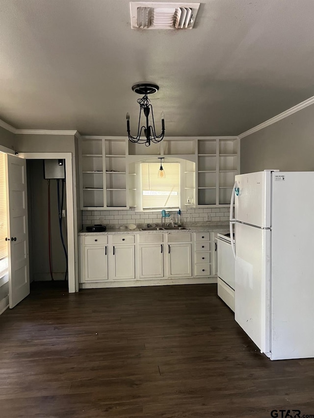 kitchen featuring white cabinetry, white appliances, dark hardwood / wood-style floors, and hanging light fixtures