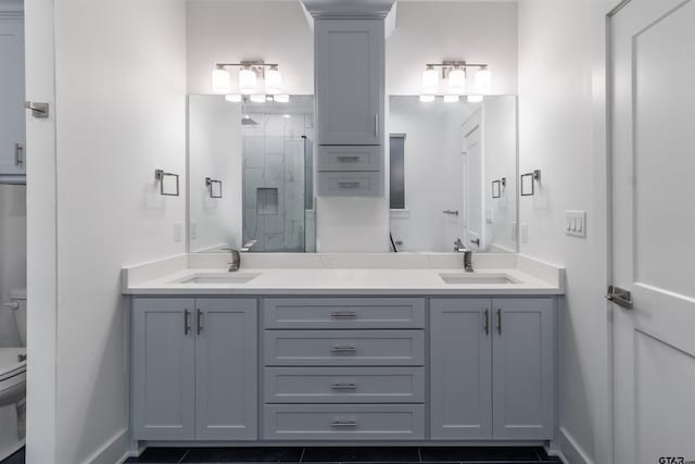 bathroom featuring vanity, toilet, a shower with door, and decorative columns