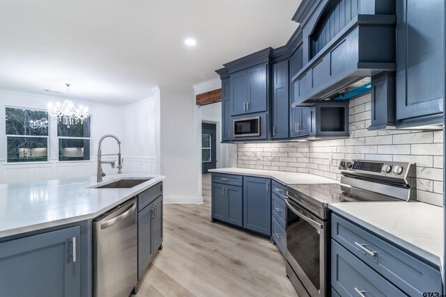 kitchen with a fireplace, an island with sink, sink, light wood-type flooring, and beam ceiling