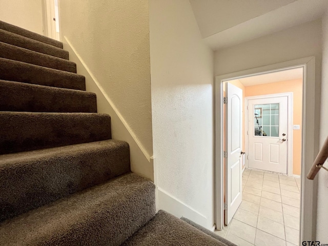 250 Autumn Wood Trl, Holly Lake Ranch, TX 75765 - staircase featuring tile patterned floors, a textured wall, and baseboards