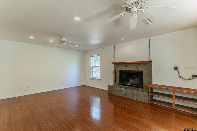 250 Autumn Wood Trl, Holly Lake Ranch, TX 75765 - unfurnished living room featuring ceiling fan, a tiled fireplace, wood finished floors, recessed lighting, and baseboards