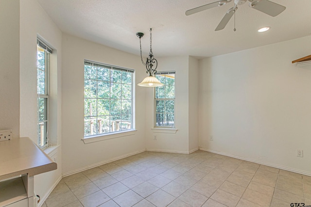 250 Autumn Wood Trl, Holly Lake Ranch, TX 75765 - unfurnished dining area featuring plenty of natural light, light tile patterned floors, a ceiling fan, recessed lighting, and baseboards