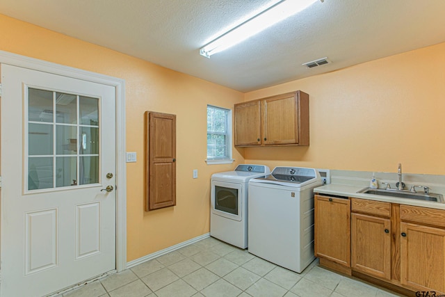 250 Autumn Wood Trl, Holly Lake Ranch, TX 75765 - clothes washing area with washing machine and clothes dryer, cabinet space, light tile patterned floors, a textured ceiling, and baseboards