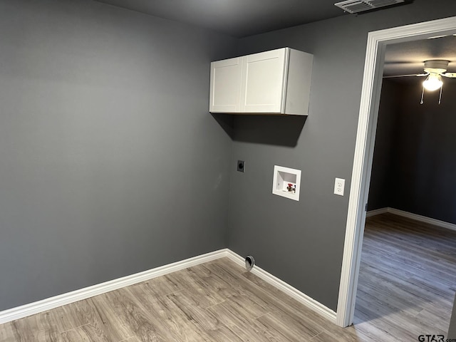 washroom with cabinets, hookup for a washing machine, light hardwood / wood-style floors, and hookup for an electric dryer