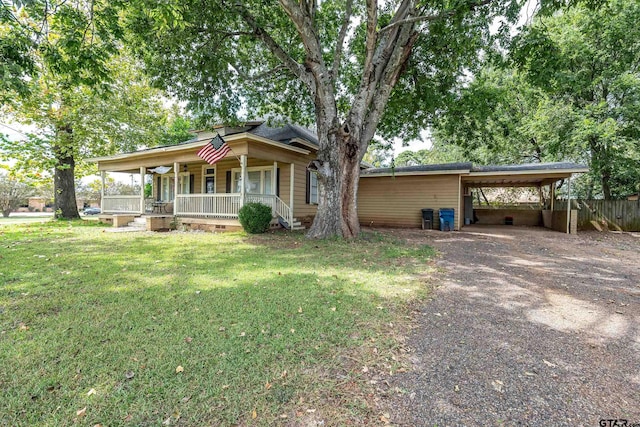 single story home with a front yard, covered porch, and a carport