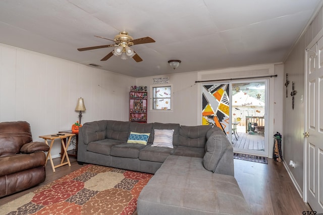 living room with wood-type flooring and ceiling fan