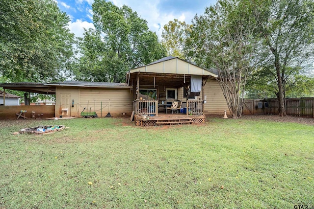 back of property with a yard and a deck