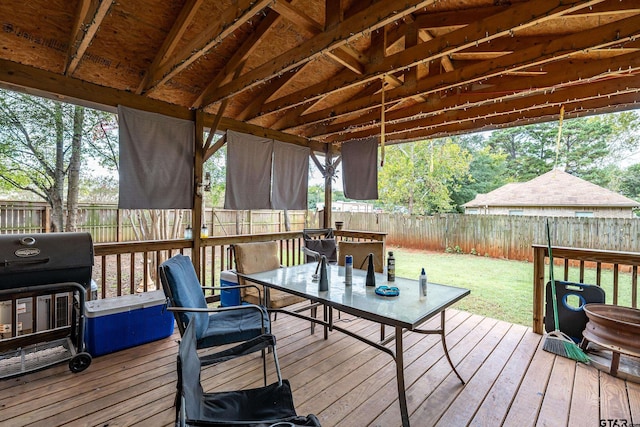 wooden deck featuring a lawn and area for grilling