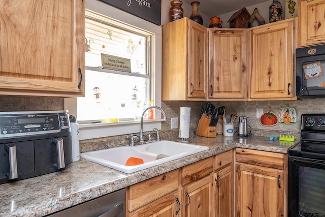 kitchen featuring black appliances, sink, and tasteful backsplash