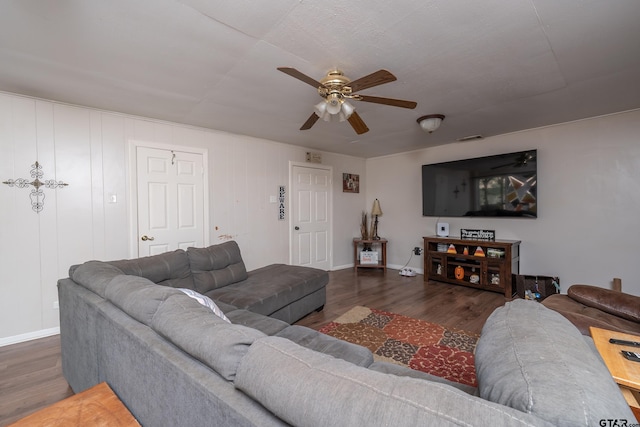 living room featuring dark hardwood / wood-style flooring and ceiling fan