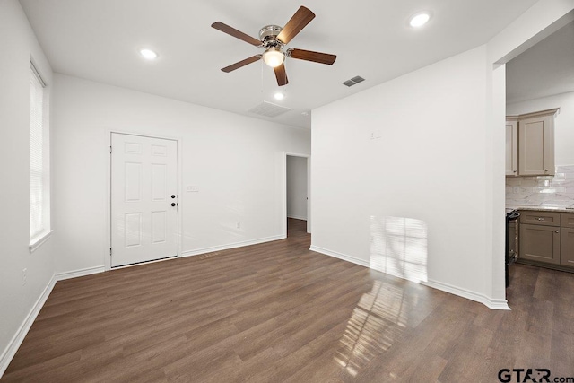 unfurnished living room with visible vents, baseboards, dark wood finished floors, and recessed lighting