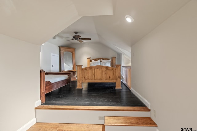bedroom featuring baseboards, wood finished floors, ceiling fan, and vaulted ceiling