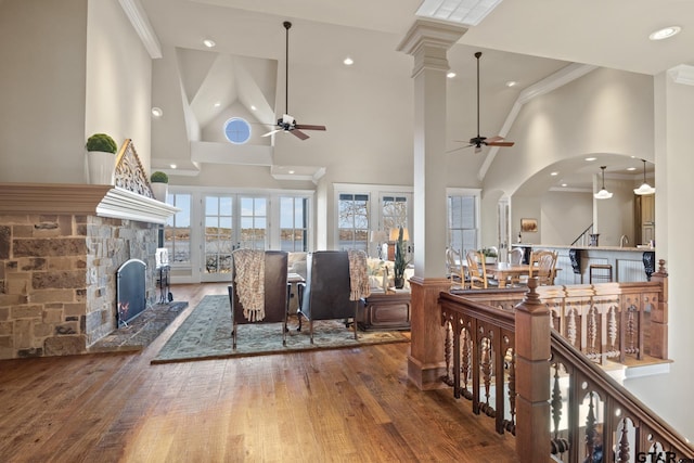 living room with high vaulted ceiling, hardwood / wood-style flooring, and ceiling fan