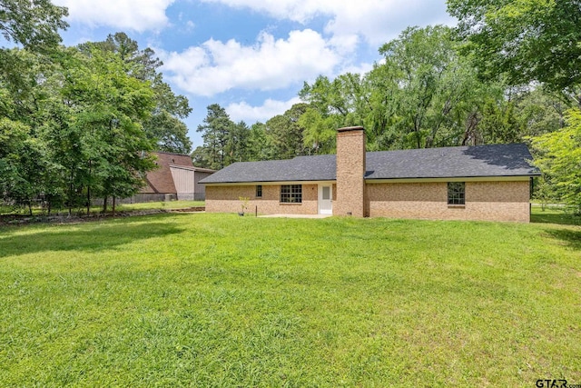 16780 Wilson Rd, Tyler, TX 75707 - back of property with fence, a yard, and a chimney