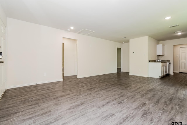 613 S Baxter, Tyler, TX 75701 - unfurnished living room featuring dark wood-style floors and recessed lighting