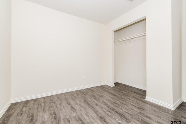 613 S Baxter, Tyler, TX 75701 - unfurnished bedroom featuring wood finished floors and a closet