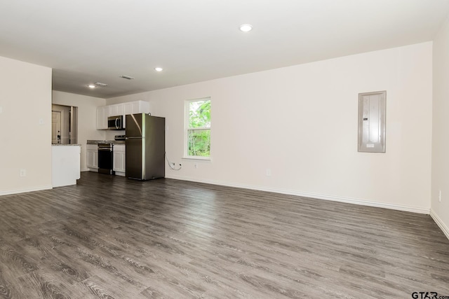 613 S Baxter, Tyler, TX 75701 - unfurnished living room with electric panel, dark wood-type flooring, and recessed lighting