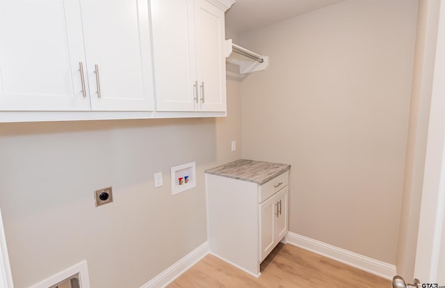 414 Bluebonnet Cir, Chandler, TX 75758 - washroom featuring electric dryer hookup, hookup for a washing machine, cabinet space, light wood-type flooring, and baseboards