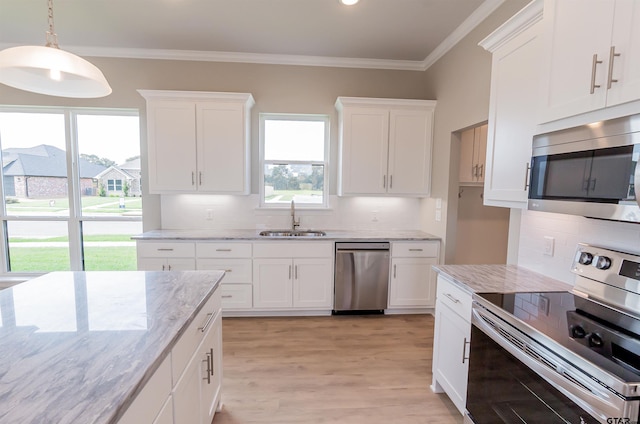 414 Bluebonnet Cir, Chandler, TX 75758 - kitchen featuring stainless steel appliances, a sink, white cabinets, tasteful backsplash, and ornamental molding