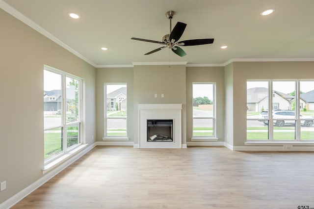 414 Bluebonnet Cir, Chandler, TX 75758 - unfurnished living room featuring light wood finished floors, baseboards, recessed lighting, plenty of natural light, and a glass covered fireplace