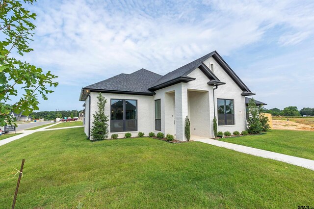 414 Bluebonnet Cir, Chandler, TX 75758 - view of front facade with brick siding, a front yard, and a shingled roof