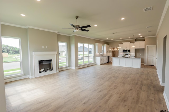 414 Bluebonnet Cir, Chandler, TX 75758 - unfurnished living room with light wood-type flooring, baseboards, recessed lighting, crown molding, and a ceiling fan