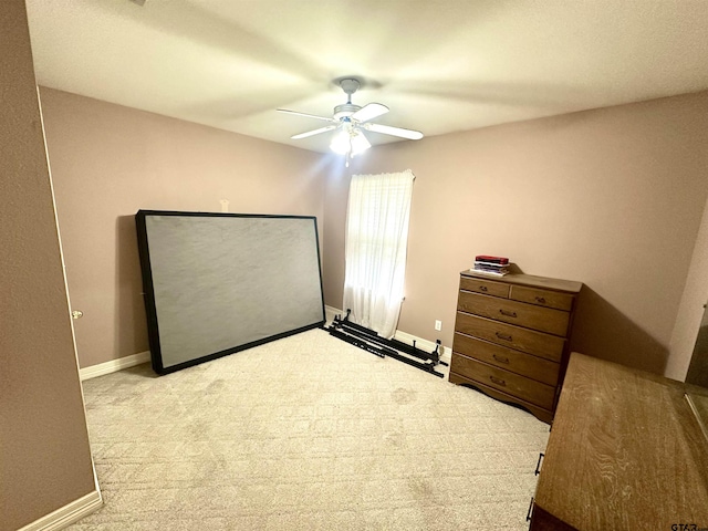 carpeted bedroom featuring ceiling fan and baseboards