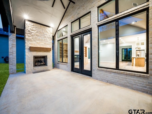 view of patio featuring an outdoor stone fireplace