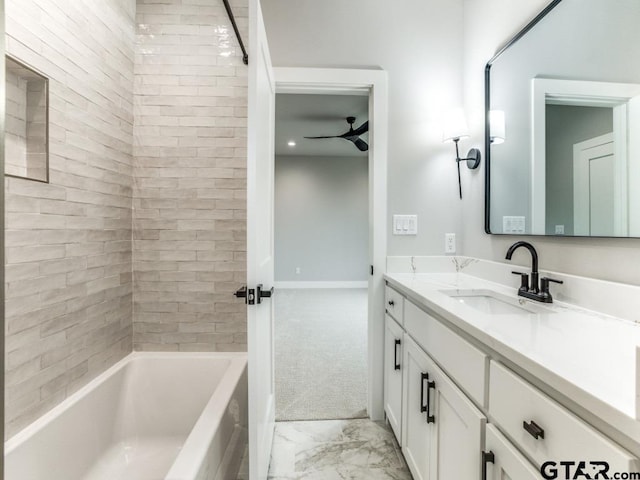 bathroom with tiled shower / bath combo, vanity, and ceiling fan