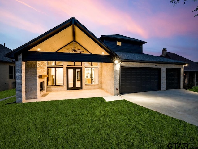 exterior space featuring a lawn and a garage