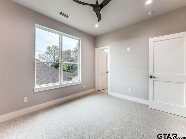 unfurnished bedroom featuring light carpet and ceiling fan