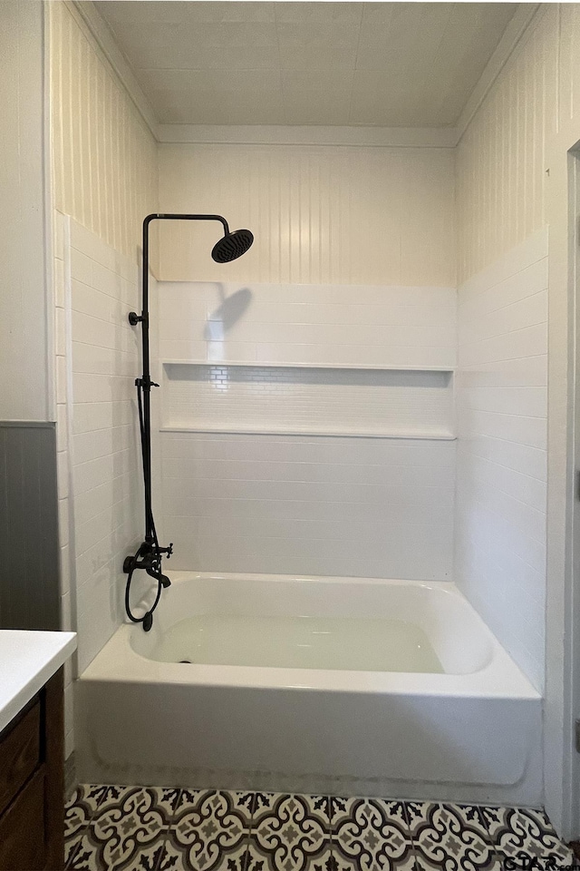 bathroom featuring bathing tub / shower combination, tile patterned floors, crown molding, and vanity