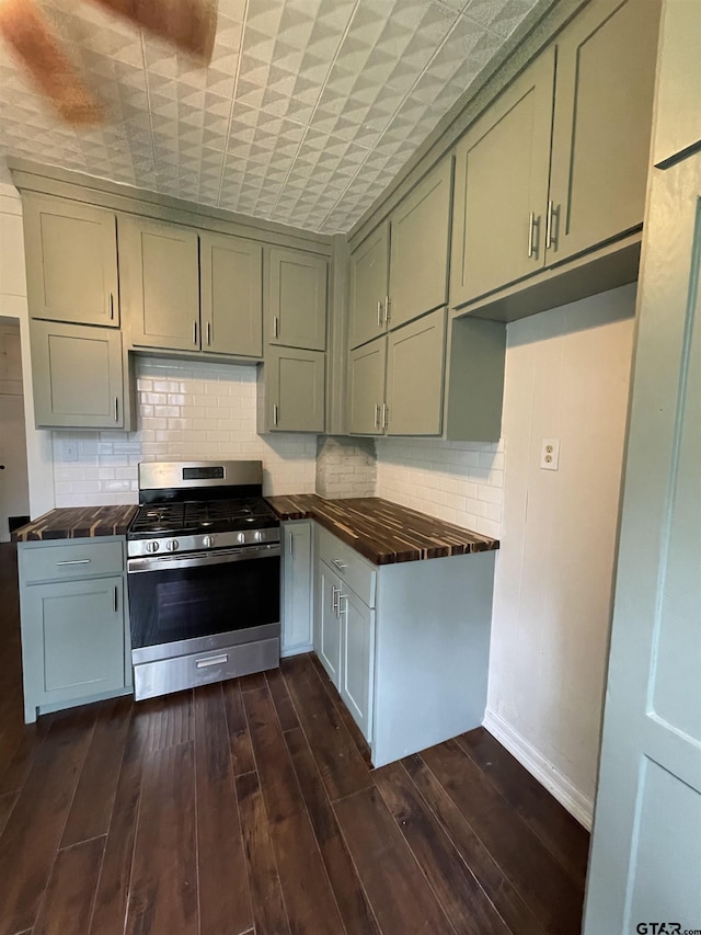 kitchen featuring decorative backsplash, stainless steel range with gas cooktop, and dark hardwood / wood-style flooring