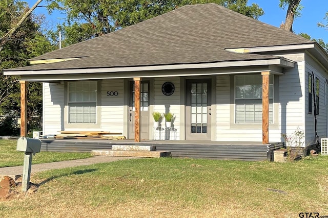 bungalow-style home with a porch and a front lawn