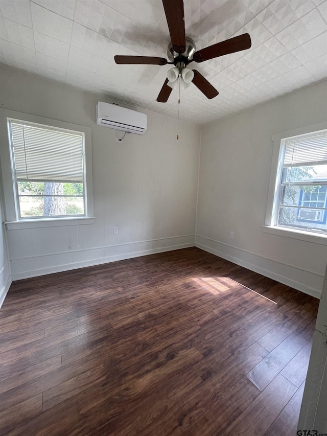 unfurnished room featuring an AC wall unit, ceiling fan, and dark wood-type flooring