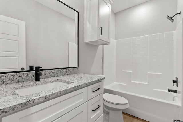 full bathroom with vanity, toilet, wood-type flooring, and bathing tub / shower combination